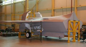 A fighter jet sitting in an airplane hanger.